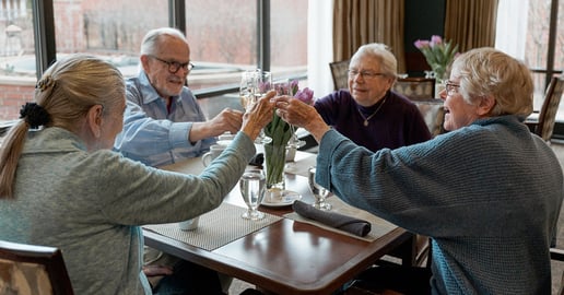 Group of seniors clinking cups together