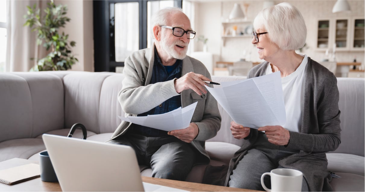 Senior couple talking over paperwork