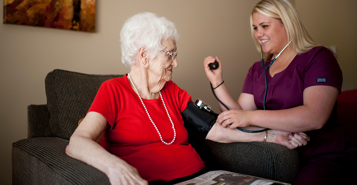 Nurse taking senior's blood pressure
