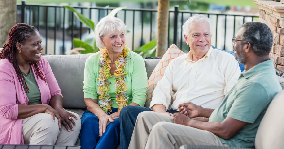 group of seniors interacting and in conversation at an assisted living community