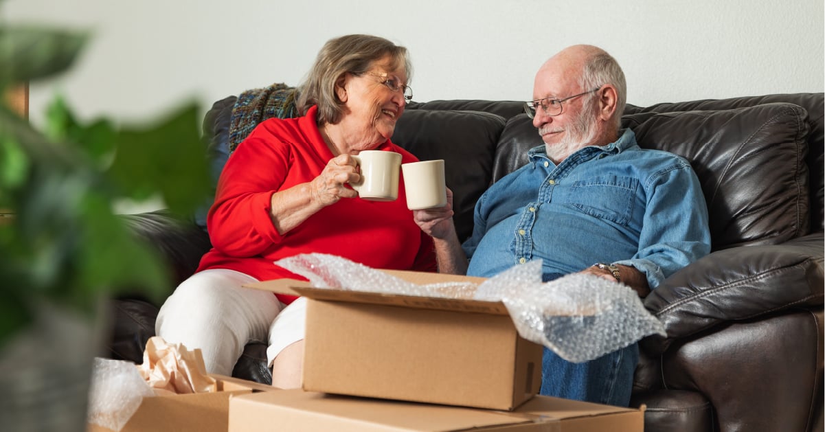 Seniors who just moved into a senior living community unpacking boxes