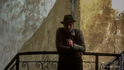 man standing against a railing