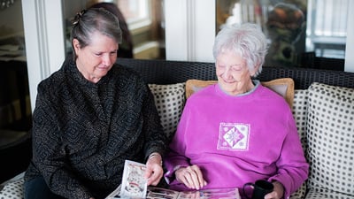 two women sitting on a couch