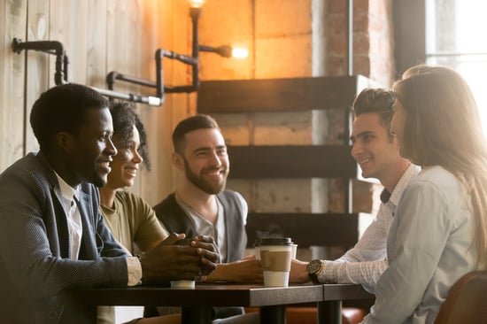 young adults talking around coffee
