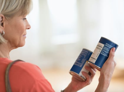 woman reading nutrition label