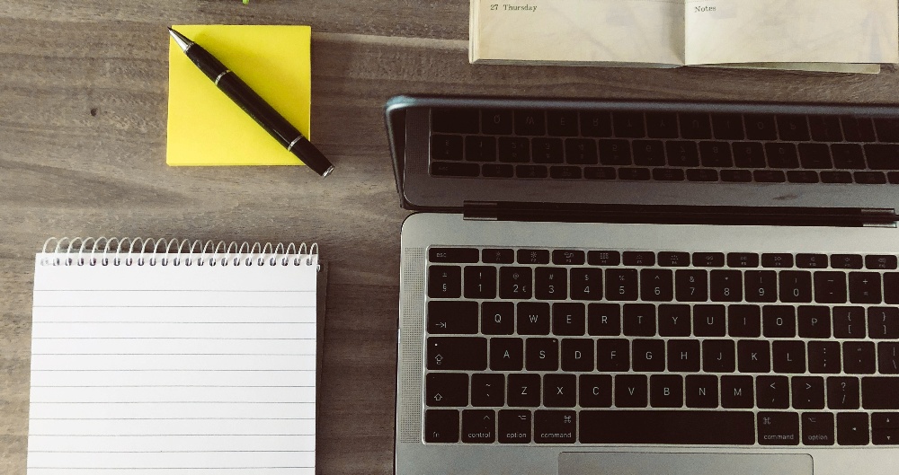top view of a laptop and notebook