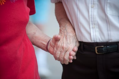 Senior couple holding hands