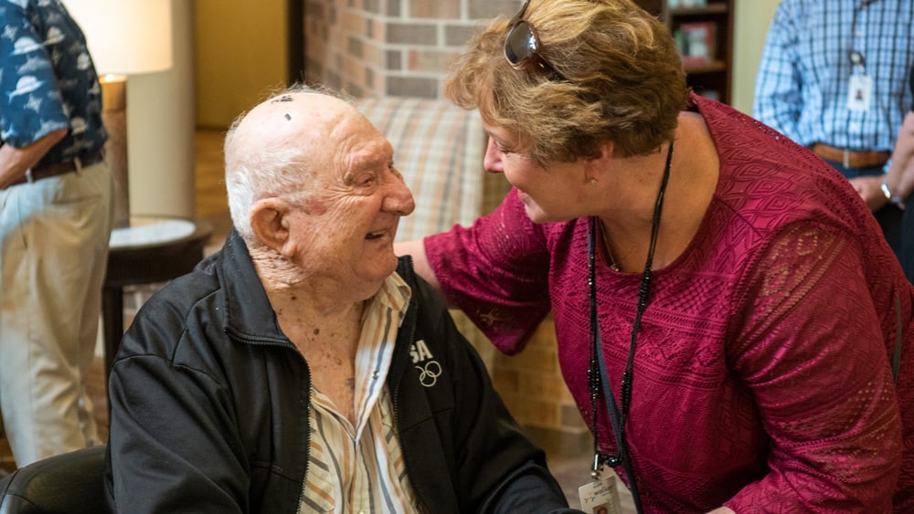 senior man interacting and smiling with woman