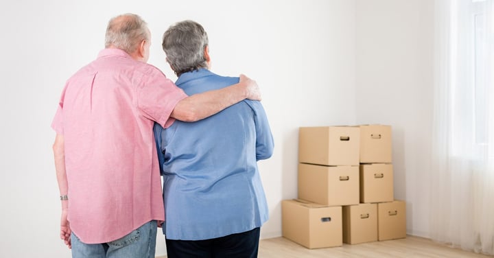 couple looking at stack of boxes