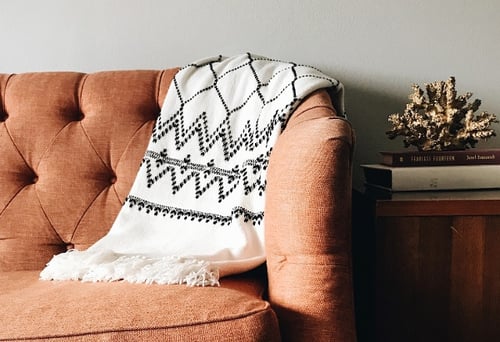 blanket hanging over couch arm
